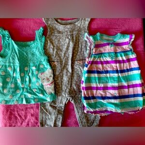 Three Carter’s newborn summer outfits.
